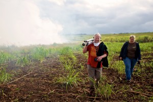 Director Danny Miller and Hilary Bingman of Hawaiian Commercial & Sugar Company on Maui at a sugar cane burn before a harvest. Photo by Baron Sekiya
