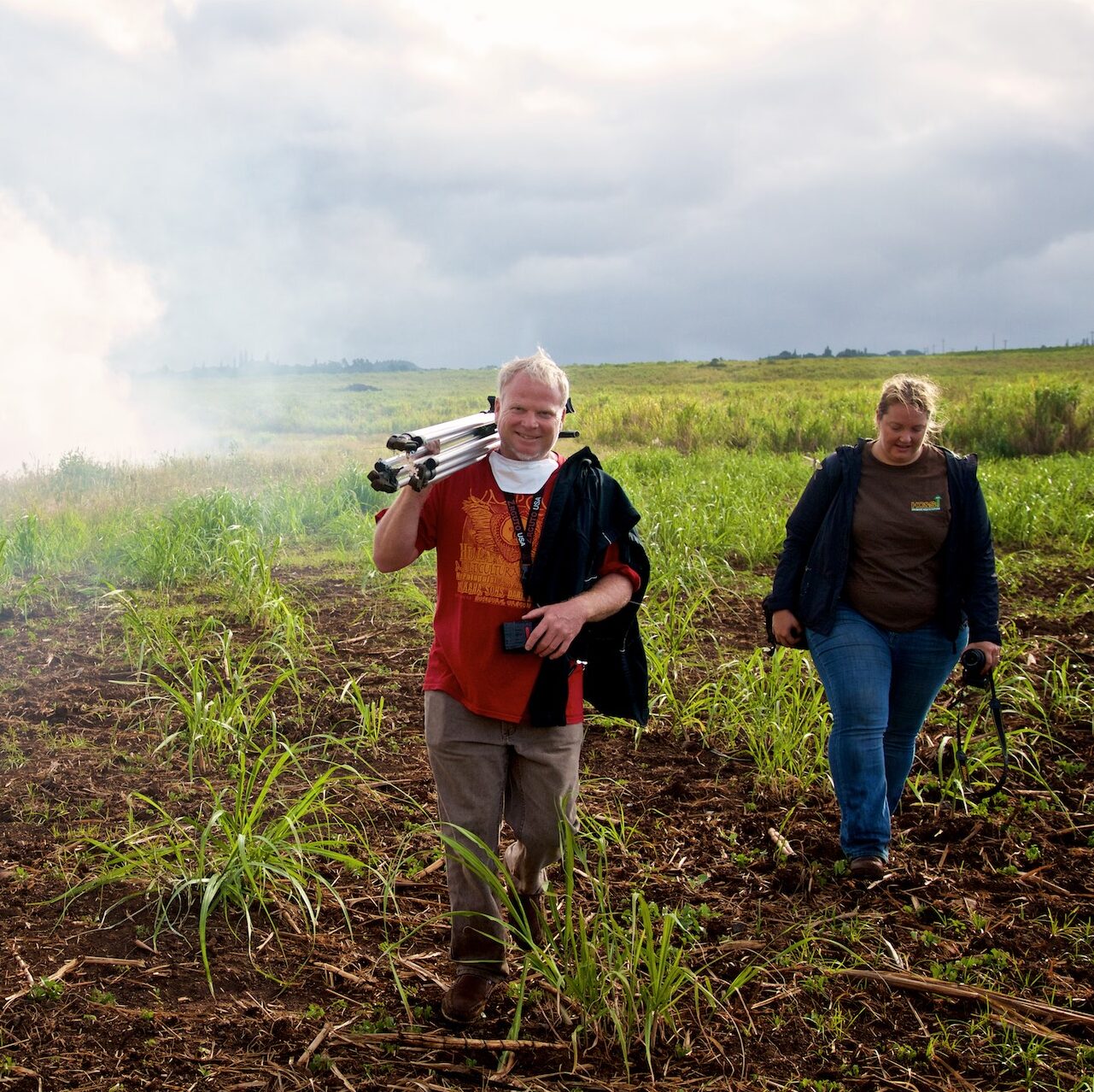 Director Danny Miller and Hilary Bingman of Hawaiian Commercial & Sugar Company on Maui at a sugar cane burn before a harvest. Photo by Baron Sekiya
